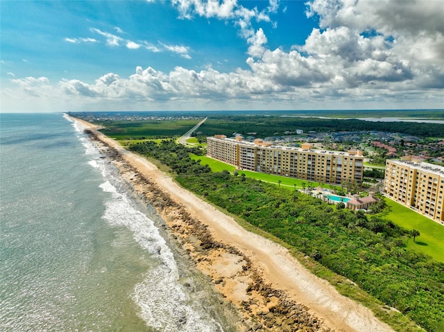 birds eye view of property featuring a view of the beach and a water view