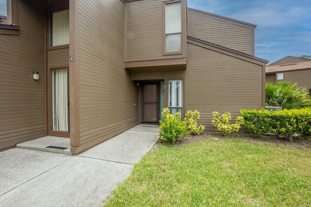 doorway to property with a yard