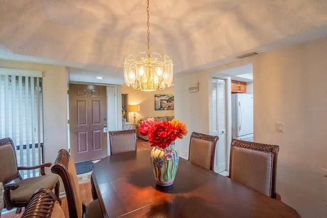 dining space with a chandelier