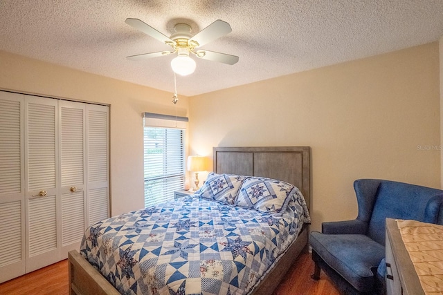 bedroom featuring a closet, ceiling fan, a textured ceiling, and hardwood / wood-style floors