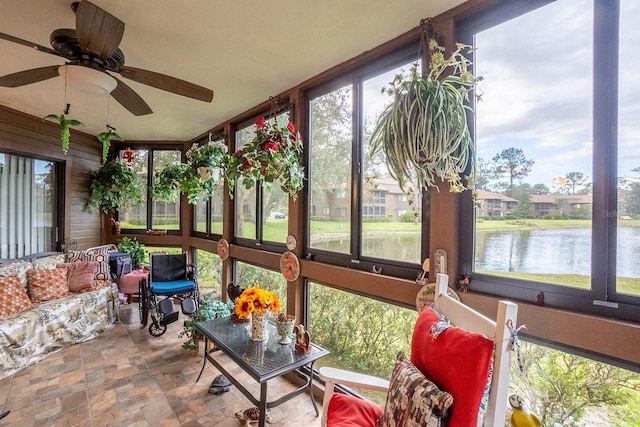 sunroom featuring plenty of natural light, a water view, and ceiling fan