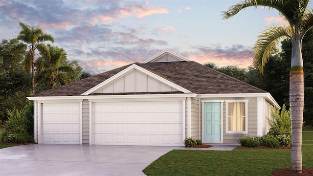 view of front of property featuring a yard and a garage