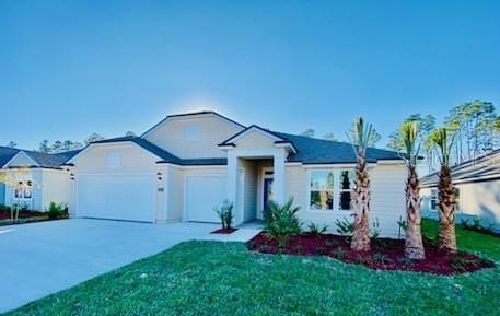 single story home with a front yard and a garage