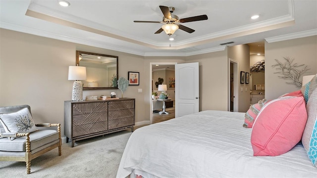 bedroom with ornamental molding, ceiling fan, and a raised ceiling