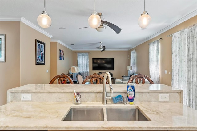 kitchen featuring crown molding, sink, and pendant lighting