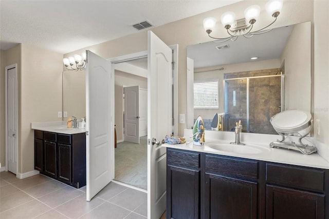 bathroom with tile patterned flooring, vanity, and a shower with shower door