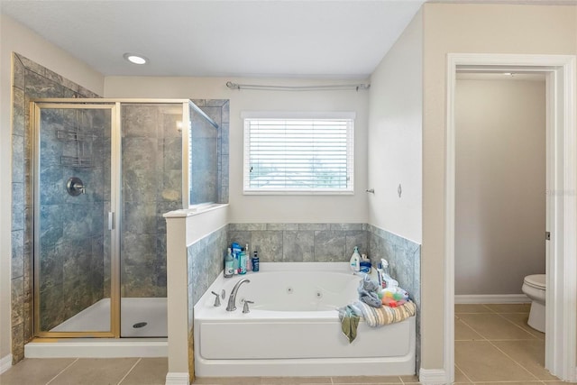 bathroom featuring tile patterned floors, toilet, and independent shower and bath