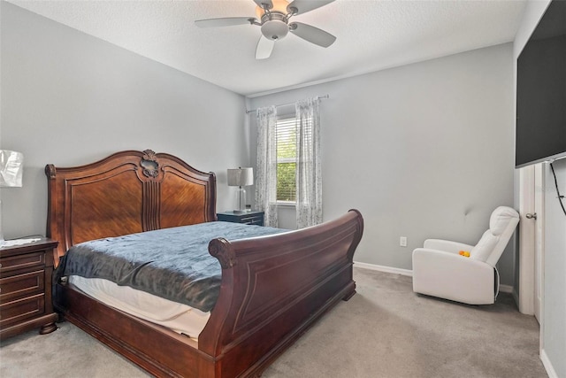 carpeted bedroom with a textured ceiling and ceiling fan