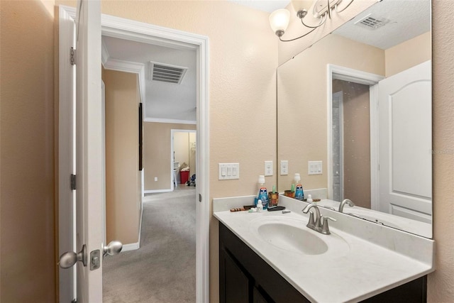 bathroom with vanity and ornamental molding