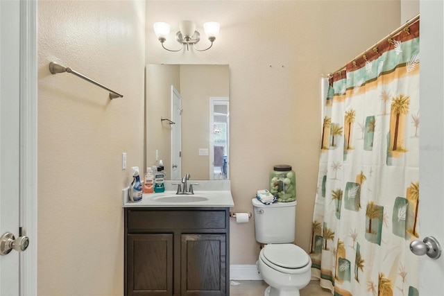 bathroom featuring vanity, toilet, and walk in shower