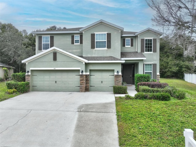 view of front facade featuring a front lawn and a garage