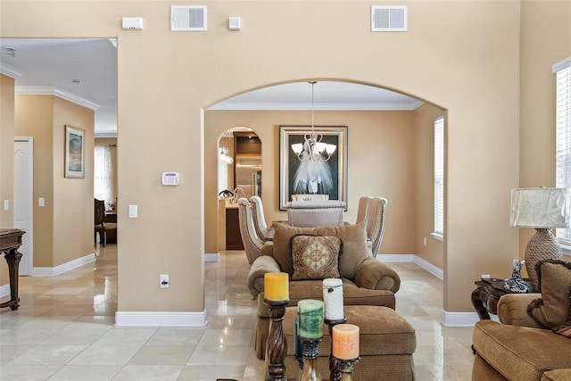 tiled living room with a chandelier and ornamental molding