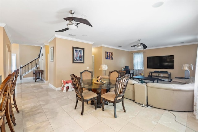 tiled dining space with ceiling fan and ornamental molding