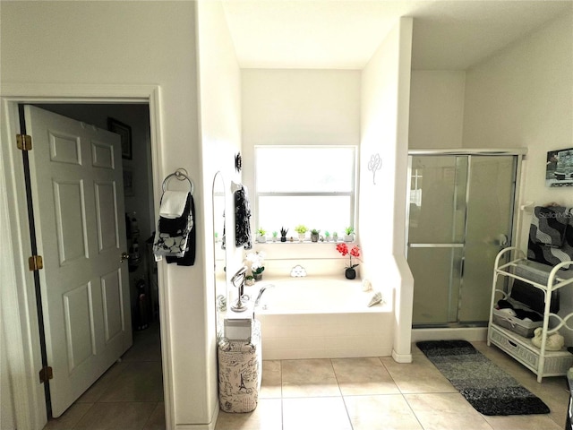 bathroom featuring tile patterned flooring and separate shower and tub