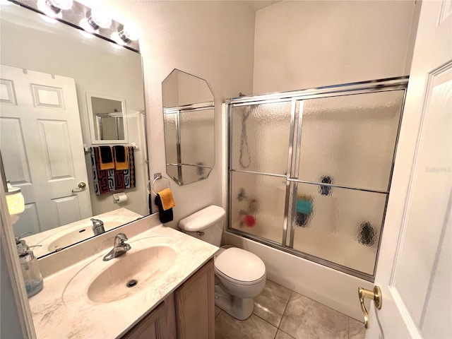 full bathroom featuring combined bath / shower with glass door, vanity, toilet, and tile patterned flooring