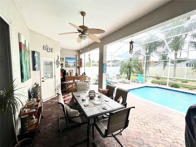 view of pool featuring ceiling fan, a lanai, and a patio area