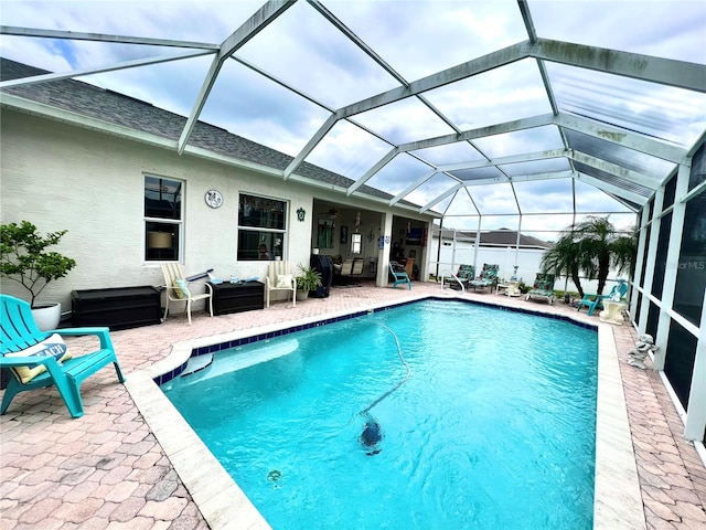 view of pool with a lanai, outdoor lounge area, and a patio area