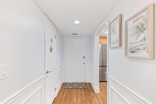 corridor with light hardwood / wood-style floors