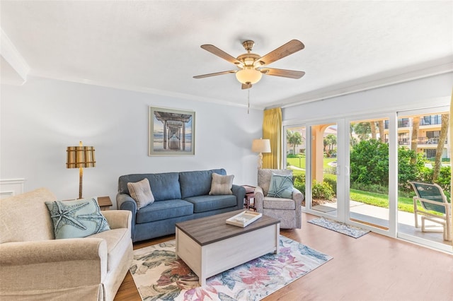 living room featuring crown molding, hardwood / wood-style floors, and ceiling fan