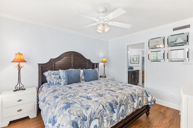 bedroom with light wood-type flooring, ceiling fan, ensuite bathroom, and crown molding