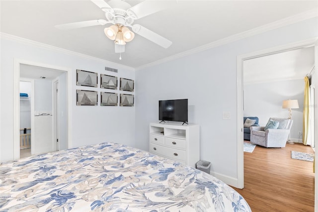 bedroom featuring ceiling fan, ornamental molding, and light hardwood / wood-style floors