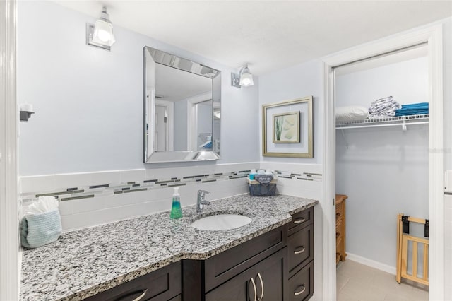 bathroom featuring tile patterned flooring and vanity