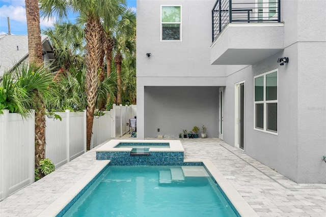 view of pool featuring a patio and an in ground hot tub