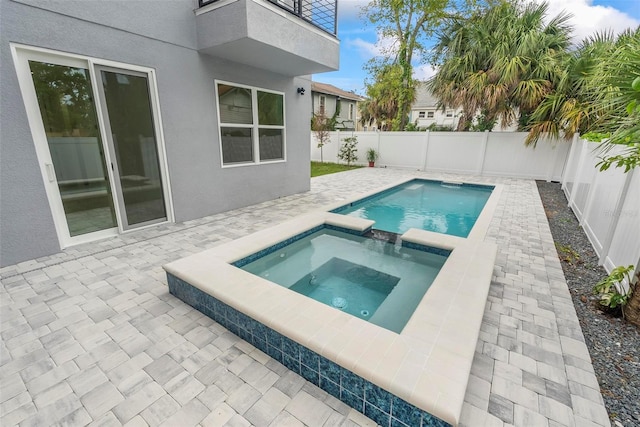 view of pool with an in ground hot tub and a patio area