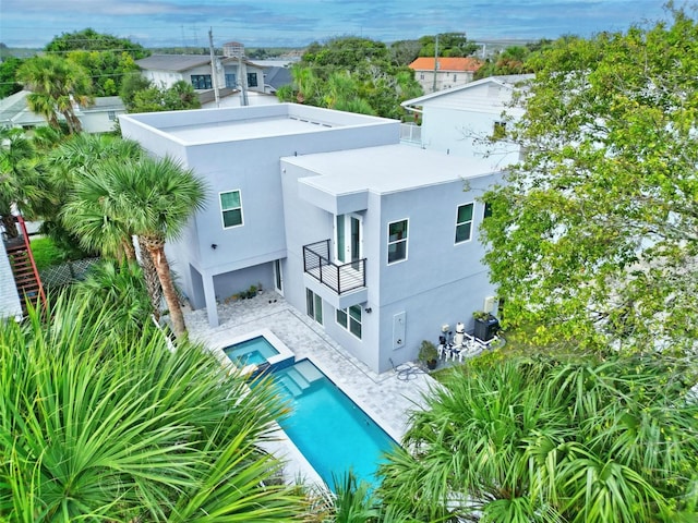 rear view of property featuring a balcony, a patio area, and central air condition unit