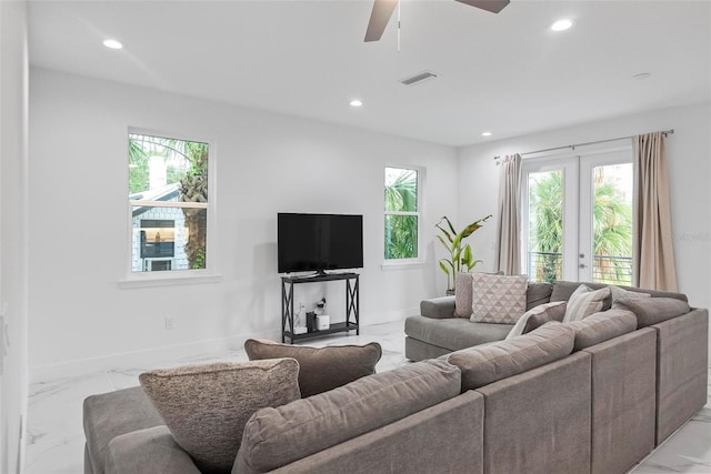 living room with ceiling fan, plenty of natural light, and french doors