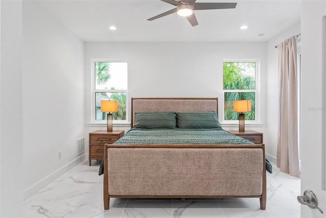 bedroom with multiple windows and ceiling fan