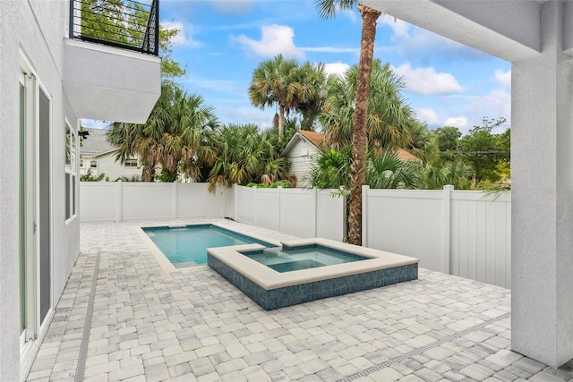 view of swimming pool with a patio and an in ground hot tub