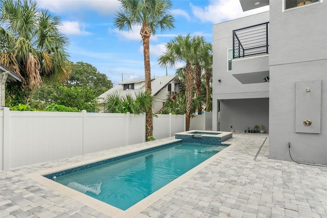 view of swimming pool with an in ground hot tub and a patio area