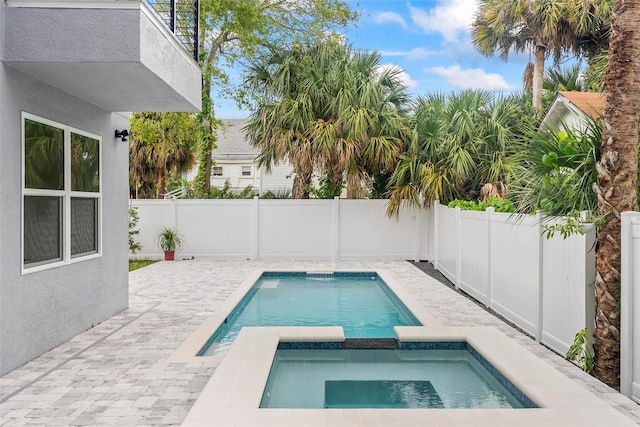 view of pool with an in ground hot tub and a patio area