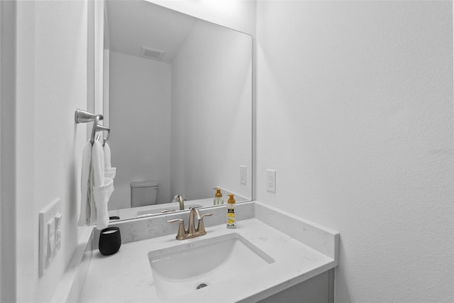 bathroom with vanity and toilet