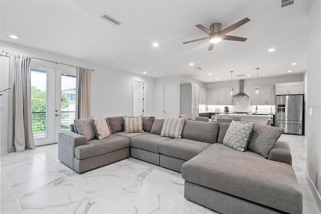 living room with ceiling fan and sink