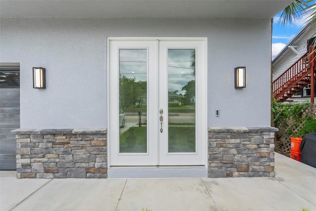 view of exterior entry featuring a patio area and french doors