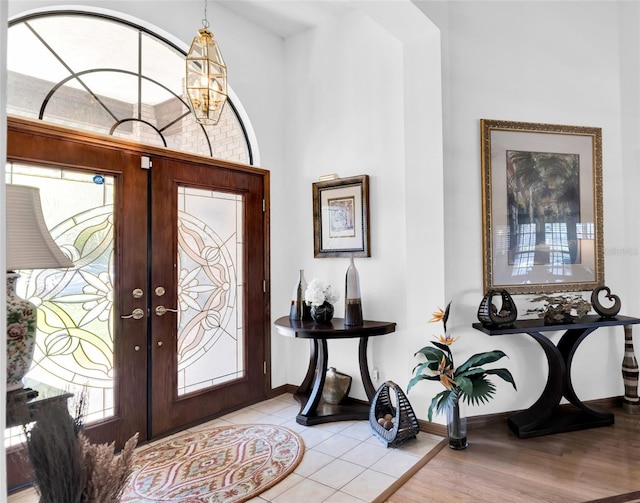 foyer entrance featuring french doors and light hardwood / wood-style floors