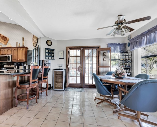 tiled dining area with ceiling fan and french doors