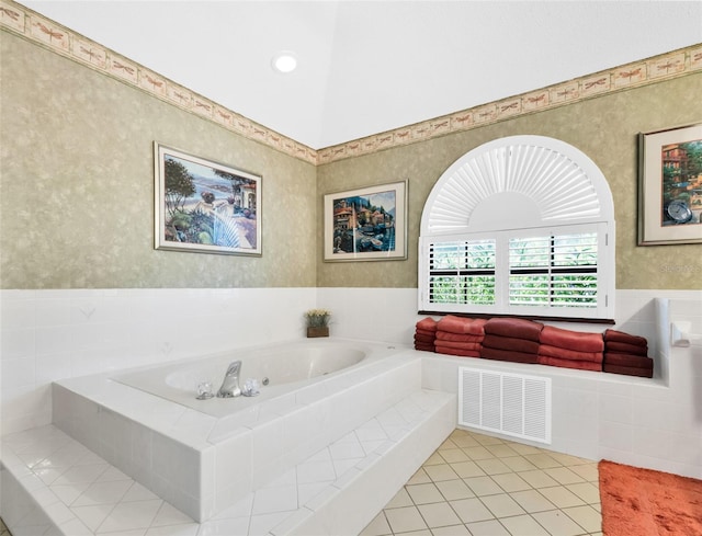 bathroom featuring tiled bath and tile patterned floors