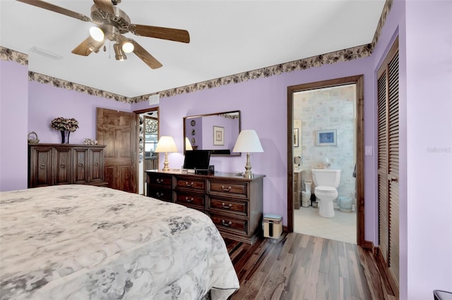 bedroom featuring connected bathroom, ceiling fan, a closet, and hardwood / wood-style flooring