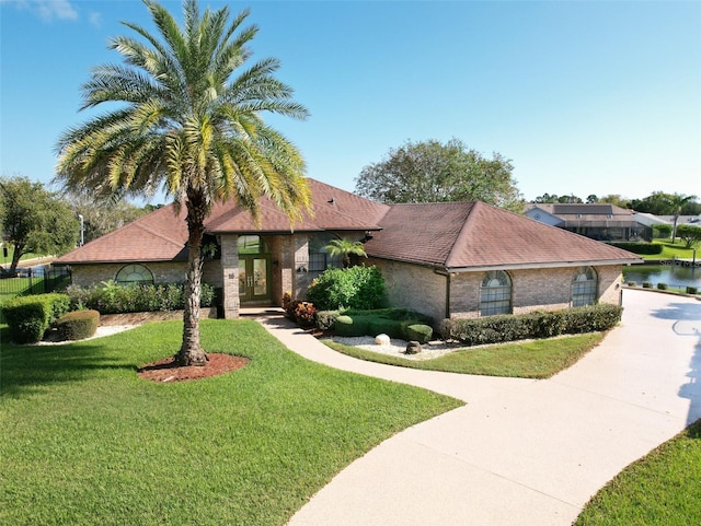 view of front facade with a water view and a front yard