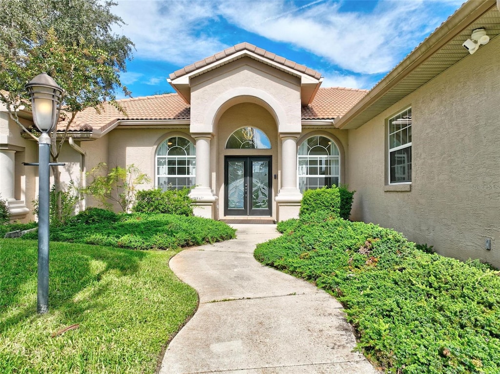 property entrance with a yard