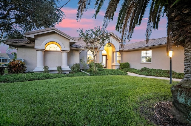 mediterranean / spanish house with a lawn