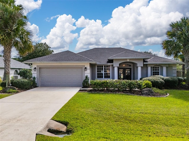 single story home with stucco siding, a front lawn, driveway, and a garage
