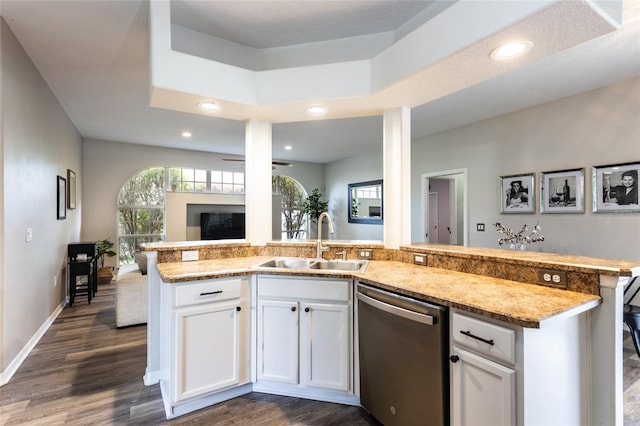 kitchen with white cabinets, sink, stainless steel dishwasher, a textured ceiling, and dark wood-type flooring