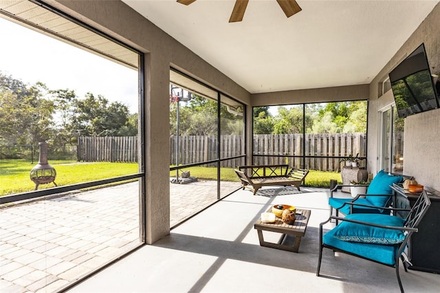 unfurnished sunroom featuring ceiling fan