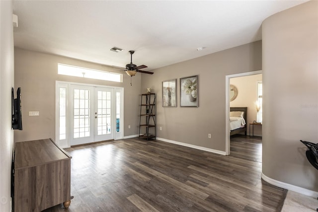 unfurnished living room with ceiling fan, french doors, and dark hardwood / wood-style flooring