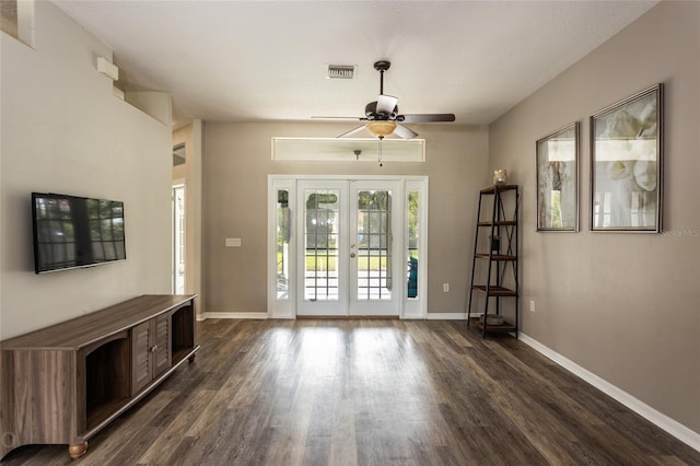 unfurnished living room featuring french doors, dark hardwood / wood-style floors, and ceiling fan