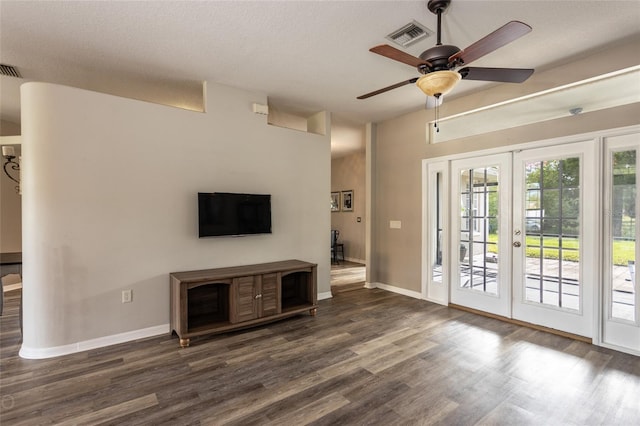 unfurnished living room featuring a textured ceiling, ceiling fan, french doors, and dark hardwood / wood-style flooring